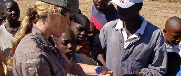 picture of Lisa taking records of people that were handed stock cards and educational pamphlets