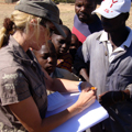 thumbnail of Lisa taking records of people that were handed stock cards and educational pamphlets